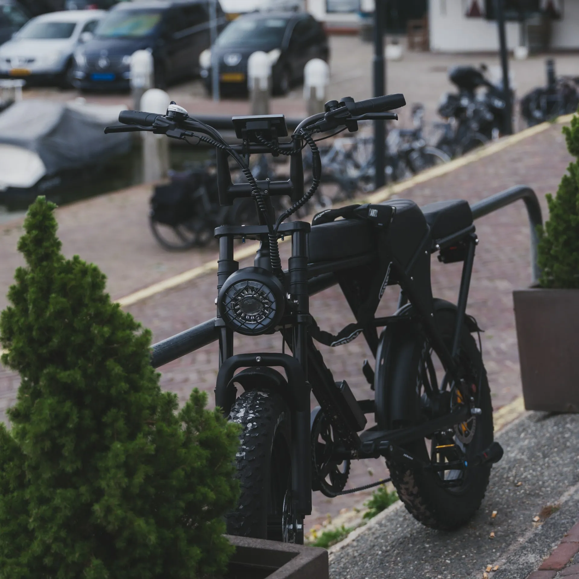Bike elétrica de pneu largo estacionada na calçada, pronta para rastreamento.